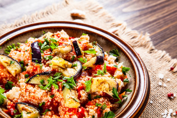 istock Couscous and vegetables on wooden table 1152614817