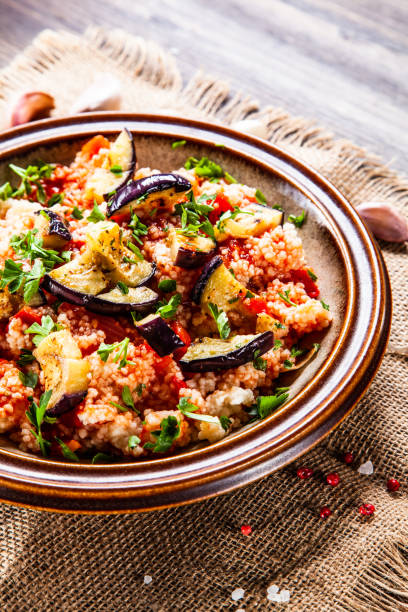 istock Couscous and vegetables on wooden table 1152614851