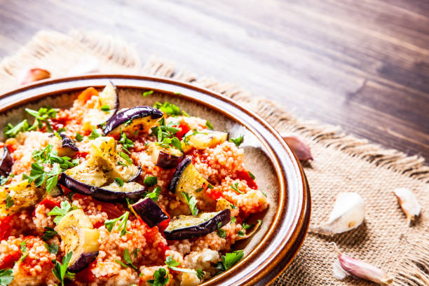 istock Couscous and vegetables on wooden table 1152615365