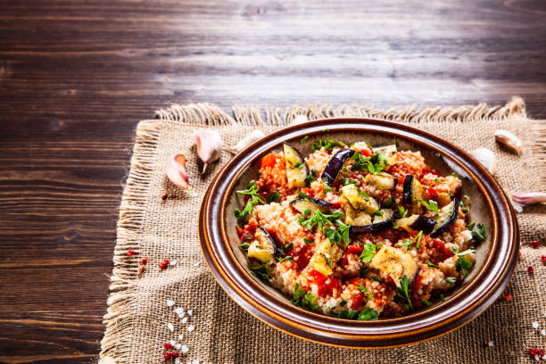 istock Couscous and vegetables on wooden table 1152615412