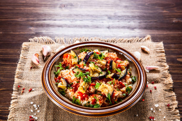 istock Couscous and vegetables on wooden table 1152615435