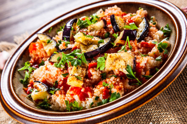 istock Couscous and vegetables on wooden table 1152615464