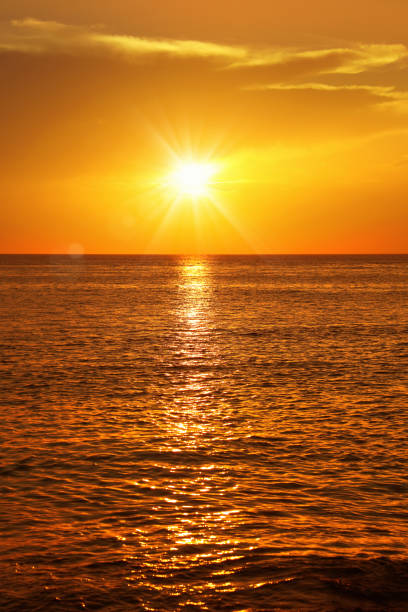 istock empty seascape with shiny sea over cloudy sky and sun during sunset 1152615491