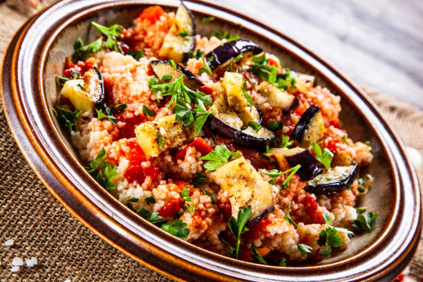 istock Couscous and vegetables on wooden table 1152615495