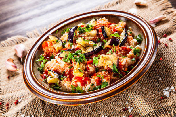 istock Couscous and vegetables on wooden table 1152615538