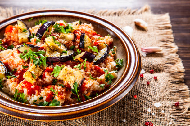 istock Couscous and vegetables on wooden table 1152615690