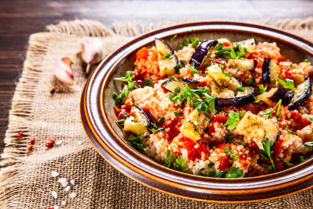 istock Couscous and vegetables on wooden table 1152615715