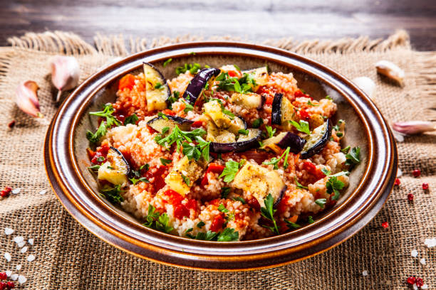 istock Couscous and vegetables on wooden table 1152615732