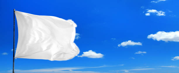 istock waving blank white flag over sunny blue sky 1152615897