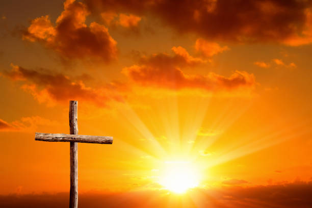 istock wooden cross over orange colored sunset sky 1152616042