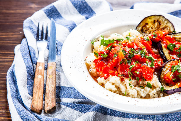 istock Couscous and vegetables on wooden table 1152616075