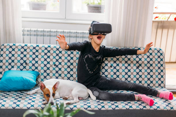 istock Little girl playing imaginary game with virtual reality headset 1152618405