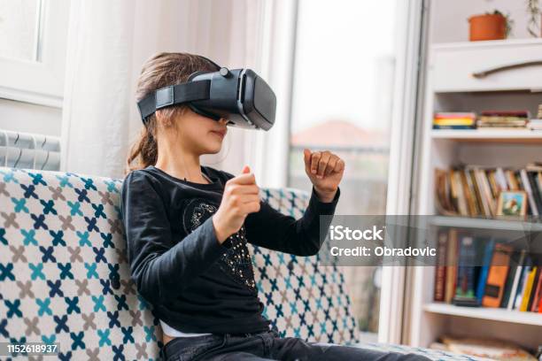 Little Girl Playing Imaginary Game With Virtual Reality Headset Stock Photo - Download Image Now