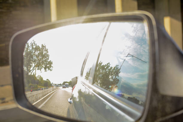 istock Looking in the wing mirror whilst driving in a car 1152619808