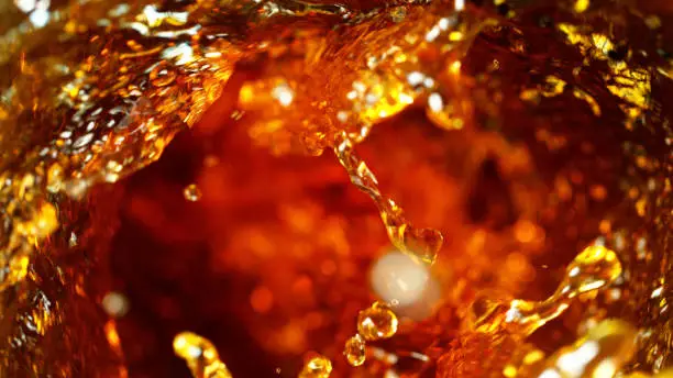 Photo of Detail of cola, tea or hard spirit beverages whirl
