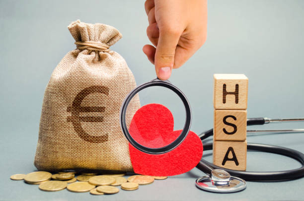 Wooden blocks with the word HSA and money bag with stethoscope. Health savings account. Health care. Health insurance. Investments. Tax-free medical expenses. Coins and euro sign. Red heart Wooden blocks with the word HSA and money bag with stethoscope. Health savings account. Health care. Health insurance. Investments. Tax-free medical expenses. Coins and euro sign. Red heart free syrian army stock pictures, royalty-free photos & images