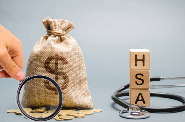 Wooden blocks with the word HSA and money bag with stethoscope. Health savings account. Health care. Health insurance. Investments. Tax-free medical expenses. Coins and dollar sign Wooden blocks with the word HSA and money bag with stethoscope. Health savings account. Health care. Health insurance. Investments. Tax-free medical expenses. Coins and dollar sign free syrian army stock pictures, royalty-free photos & images
