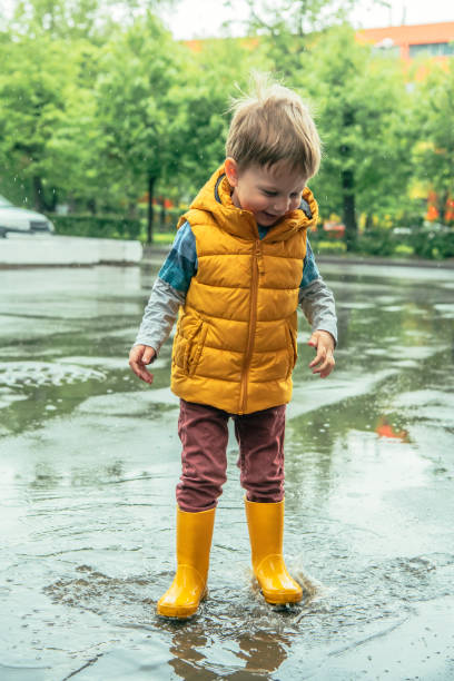 istock Cute little boy having fun at rainy day 1152622952