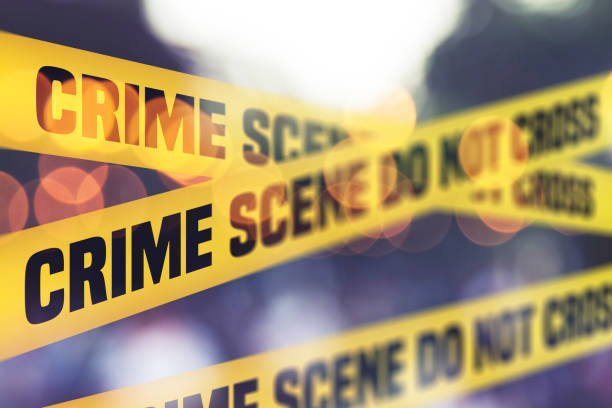 Crime Scene Tape Barrier In Front Of Defocused Background Crime Scene Tape Barrier In Front Of Defocused Background criminal justice stock pictures, royalty-free photos & images