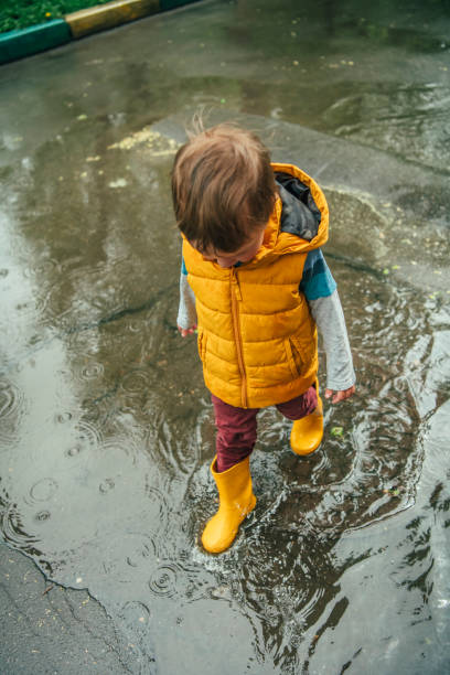 istock Cute little boy having fun at rainy day 1152623556