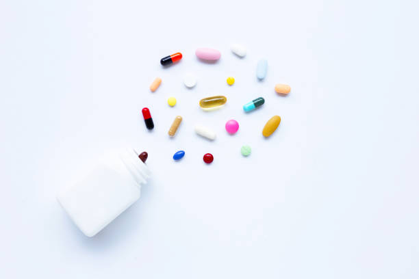 istock Colorful tablets with capsules and pills on white. 1152623572