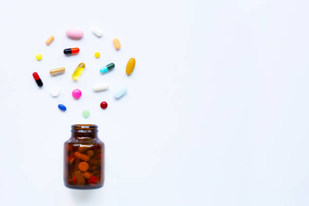 istock Colorful tablets with capsules and pills on white. 1152623599