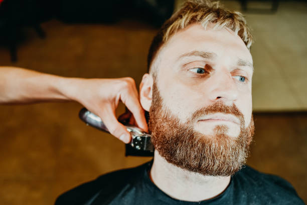 istock the barber cuts his beard to a man in the salon 1152624983