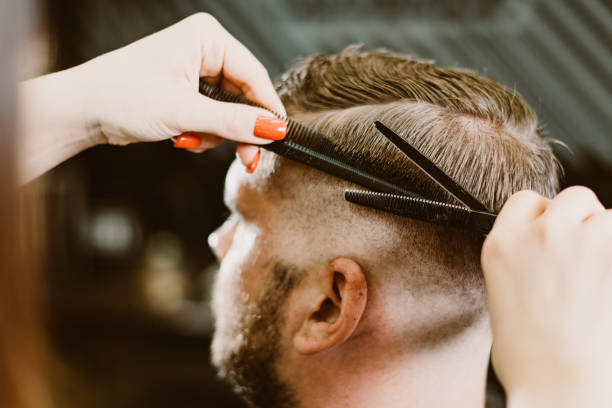 istock the barber cuts a bearded man with scissors in the salon 1152625179