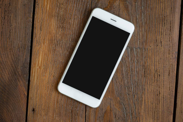 istock Phone screen empty on wooden teble top view 1152627435