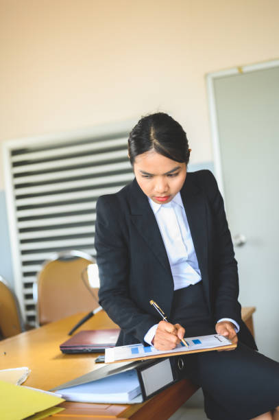 Working women are stressed at the office desk.