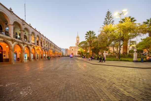 People outside the Basilica Cathedral of Arequipa at Plaza de Armas, Peru, at the evening.