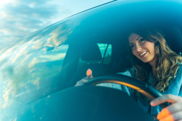 istock Young woman driving a car 1152633220