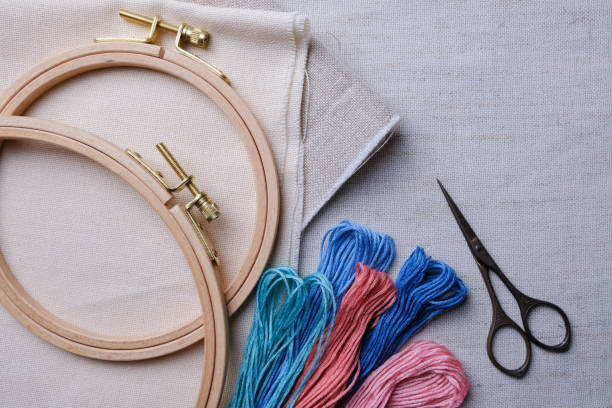 istock Embroidery set. White linen fabric, embroidery hoop, threads and needls and scissors. Copy space 1152635472