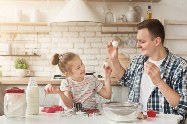 istock Happy family cooking together in kitchen 1152635780