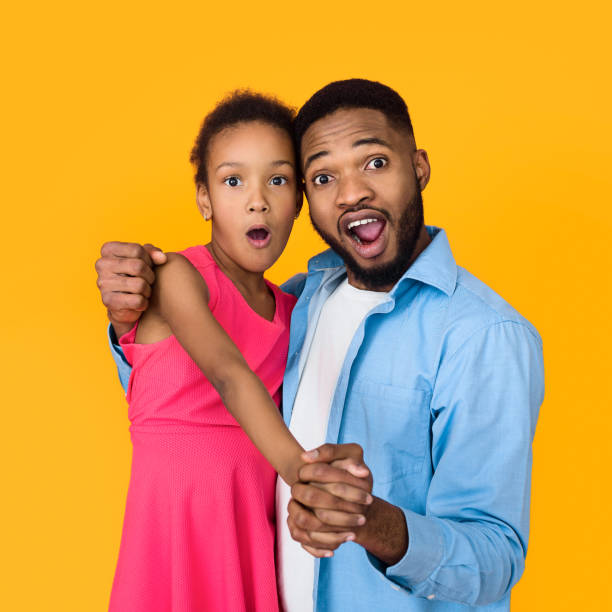 istock Surprised father and daughter looking at camera 1152640426