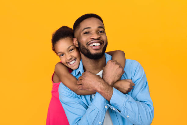 istock Little girl hugging father, having fun over background 1152640430