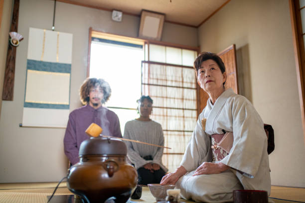 istock Japanese tea master preparing to make tea for two tourists 1152641620