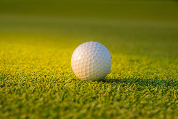 istock Golf ball putting on green grass  golf in game at golf course with blur background and sunlight ray 1152642184