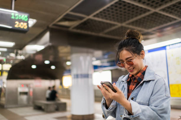 istock Young tourist using phone on subway station 1152643984
