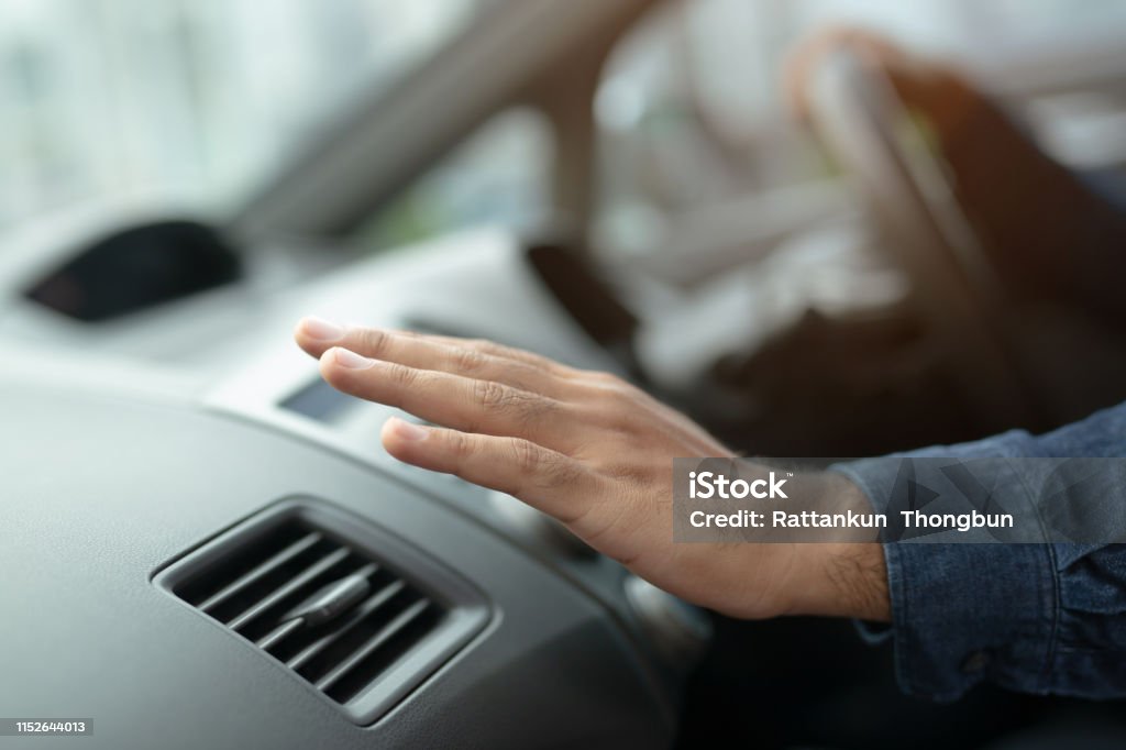 Closeup of hand driver man checking adjusting air from conditioning the cooling system with flow of cold air in car. Leave space for writing text. Car Stock Photo