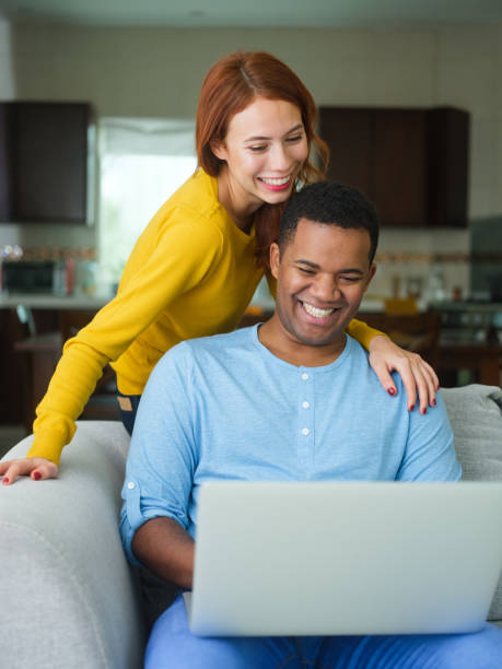 istock Mixed raced couple looking at a laptop together 1152646352
