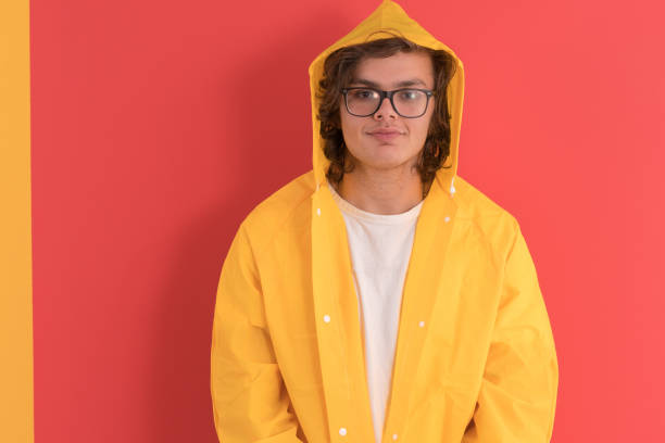 istock Young man wearing raincoat 1152647354