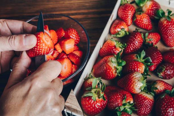 istock hands cutting strawberries with a knife 1152647471