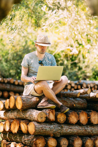 istock Young Urban Man Working with Laptop in Forest 1152647605
