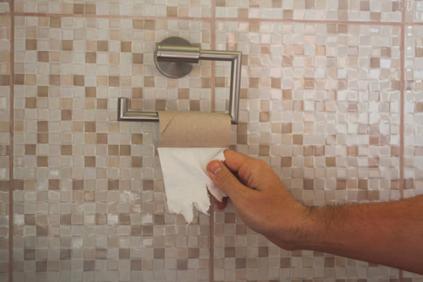 istock hand with torn toilet paper 1152647798