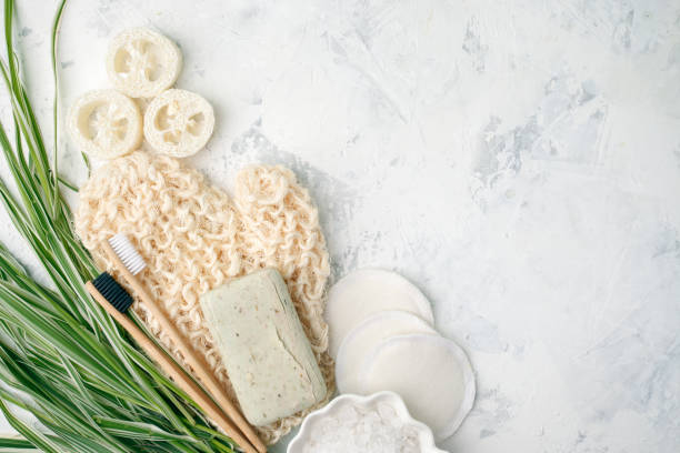 istock Plastic free background. Personal care products made from natural materials: bamboo tooth brushes, cotton pads, soap, green leaf. Zero waste concept. Flat lay 1152648859