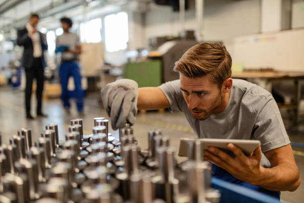 istock Manual worker using touchpad and analyzing steel rods in metal factory. 1152648879