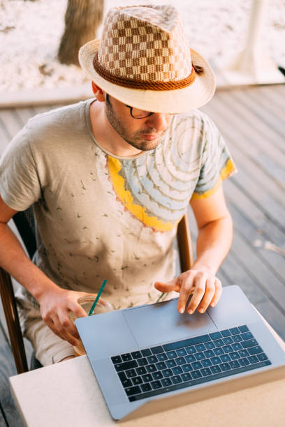 istock Young Man Working with Notebook at Coffee Shop 1152648958