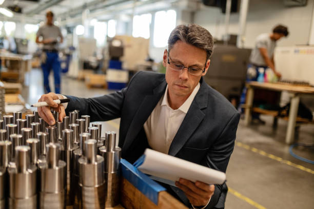 istock Engineer reading reports while performing quality control in a steel factory. 1152649205
