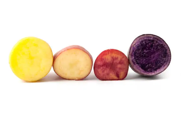 Potatoes with different pigmentation (Solanum tuberosum) on a white background